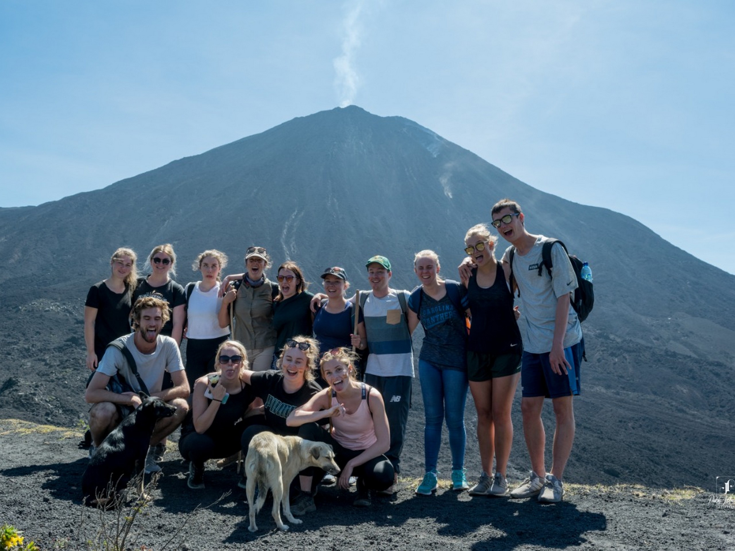 Group posing near Pacaya volcano