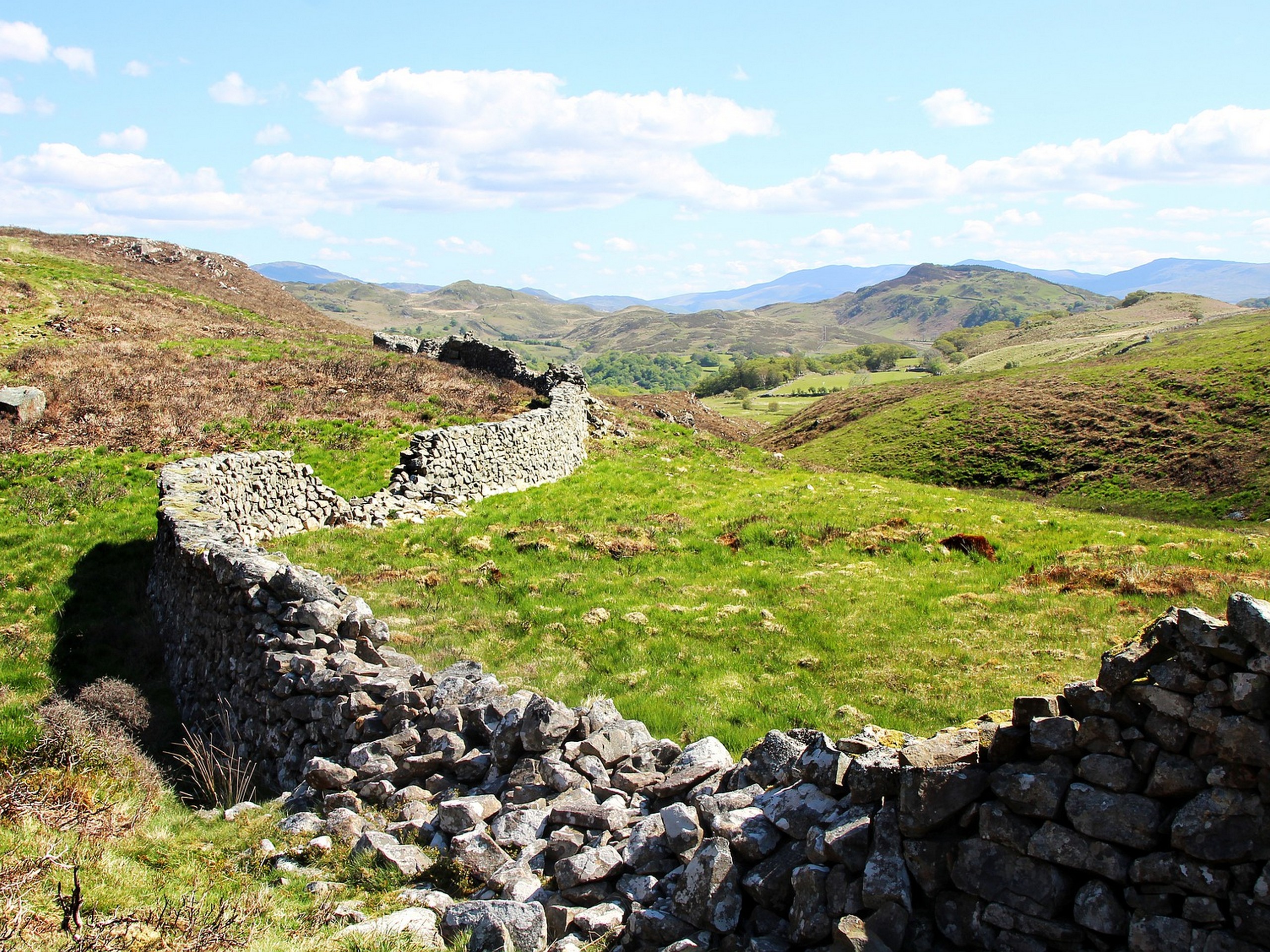 Crossing the green pastures in Wales while on a self-guided Snowdonia Slate trail