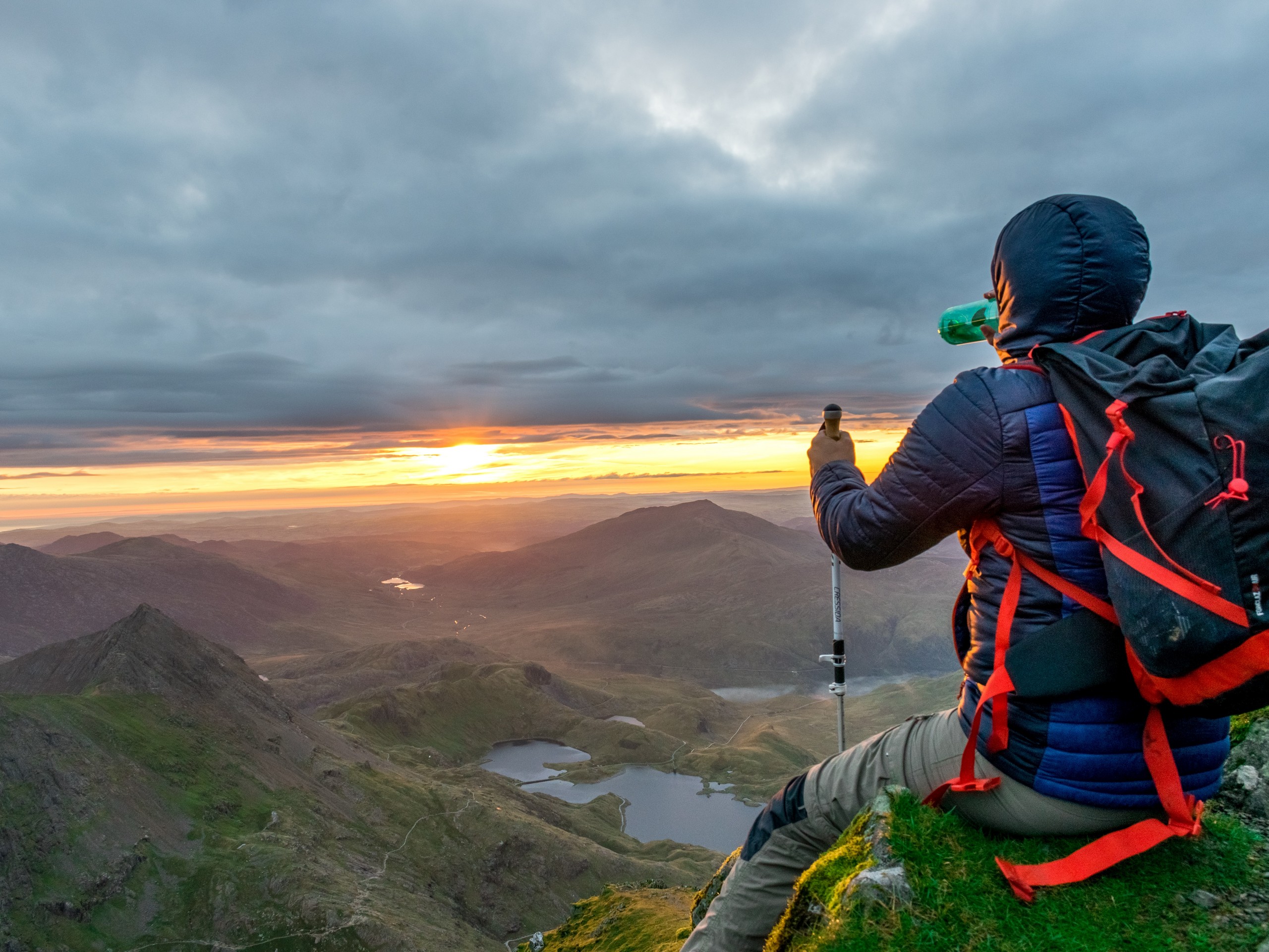 Hiker watching the sunrise from Snowdonia Slate trail
