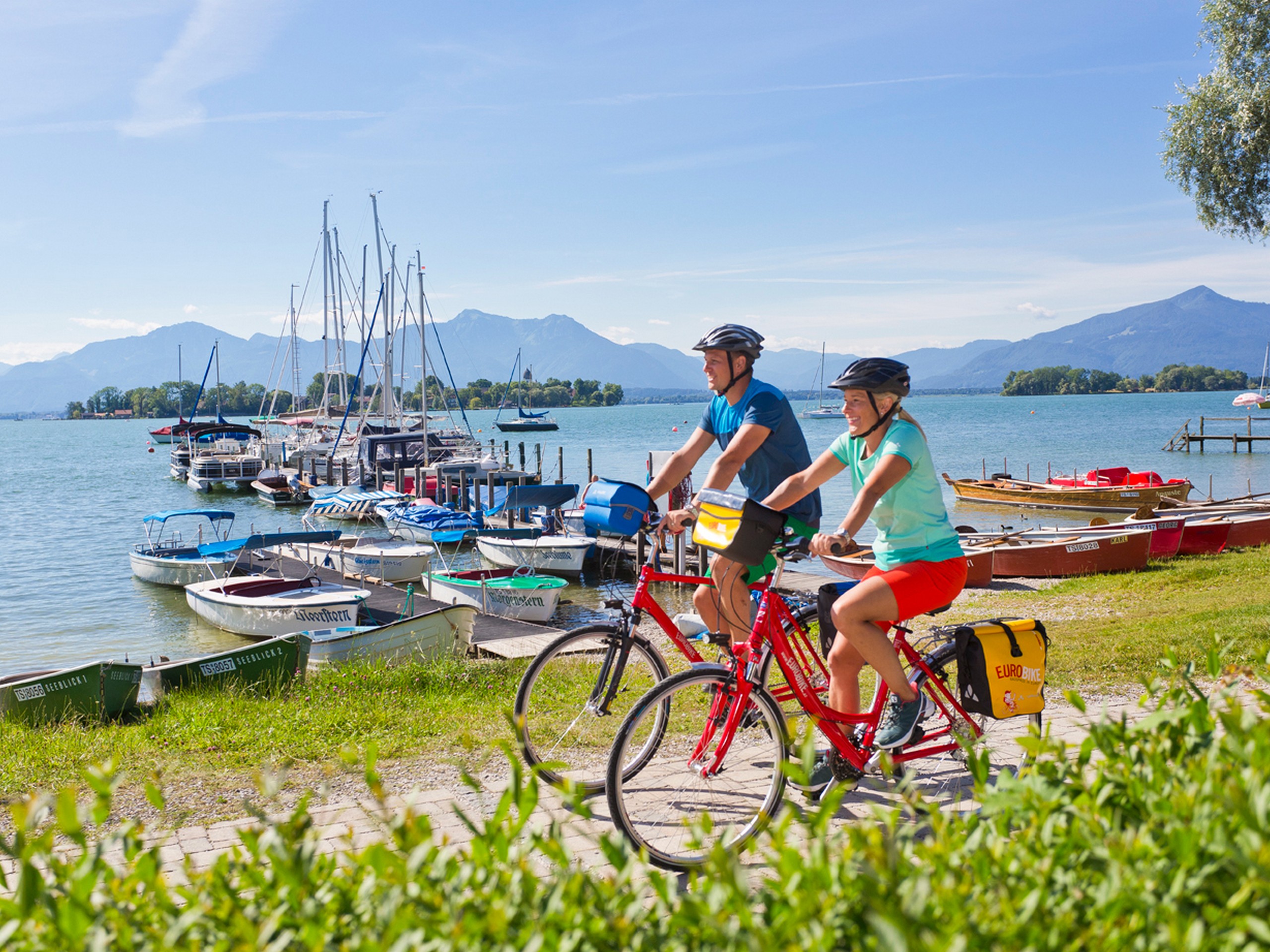 Couple cycling along the Chiemsee Lake