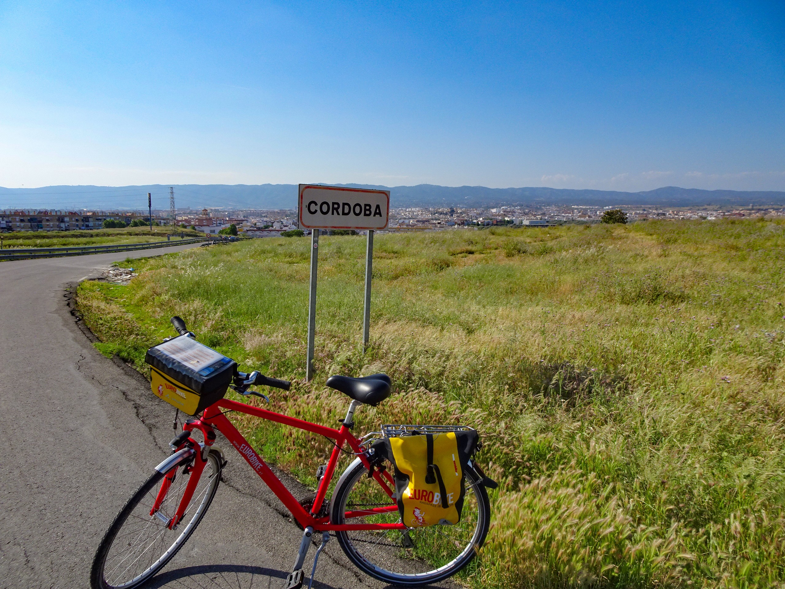 Bike parked near the roadsign of Cordoba, Spain