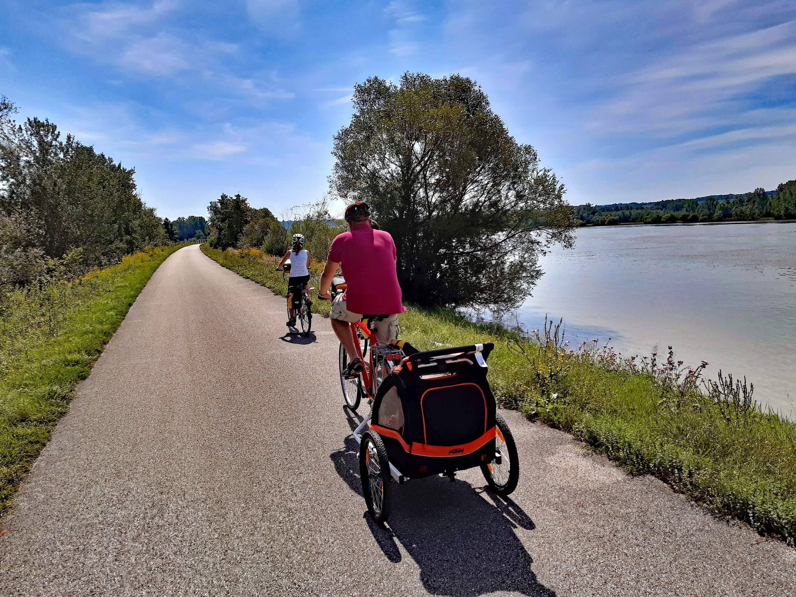 Family biking on a cycling path along the Danube river