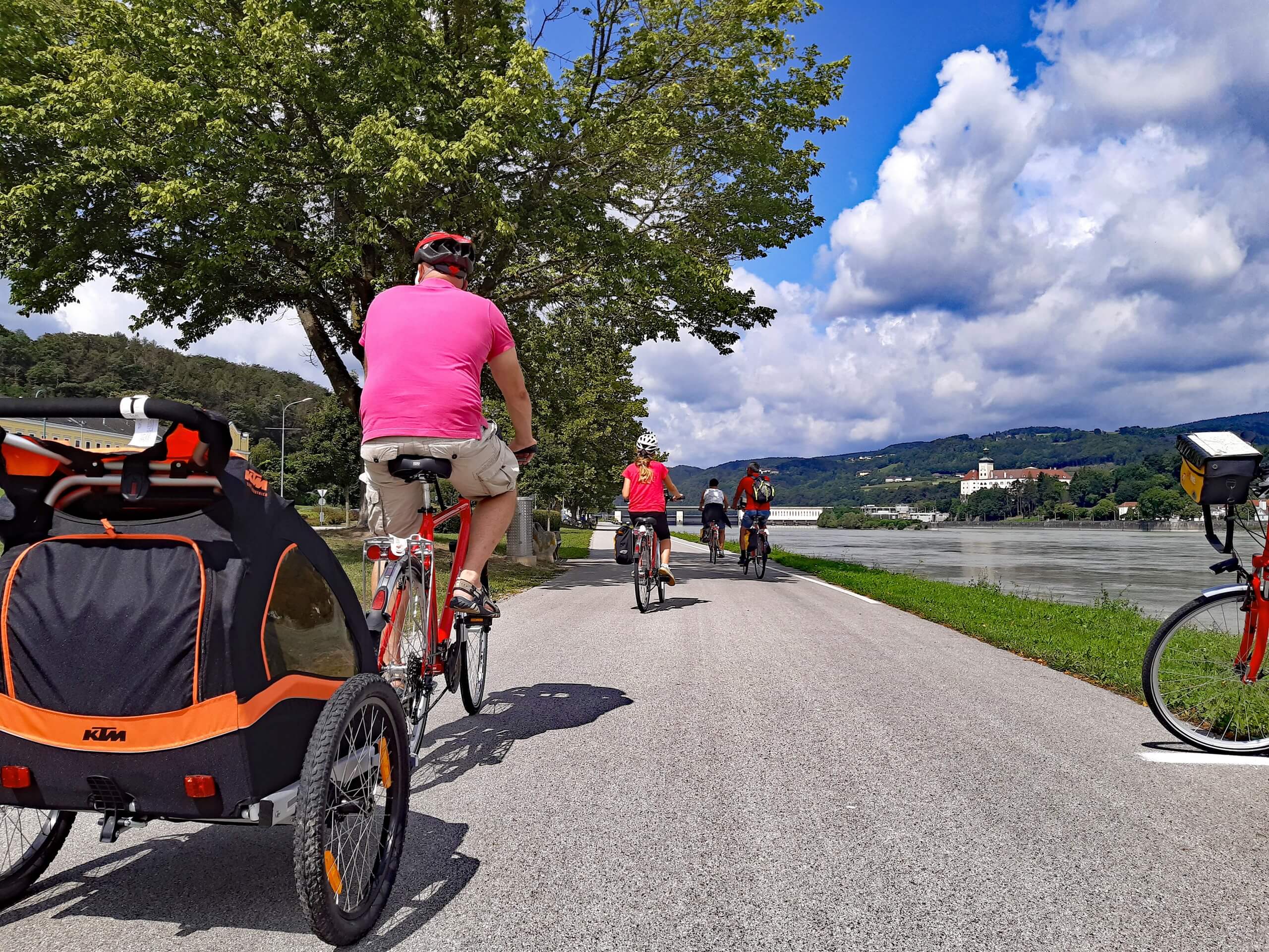 Family cycling with kids along the Danube river