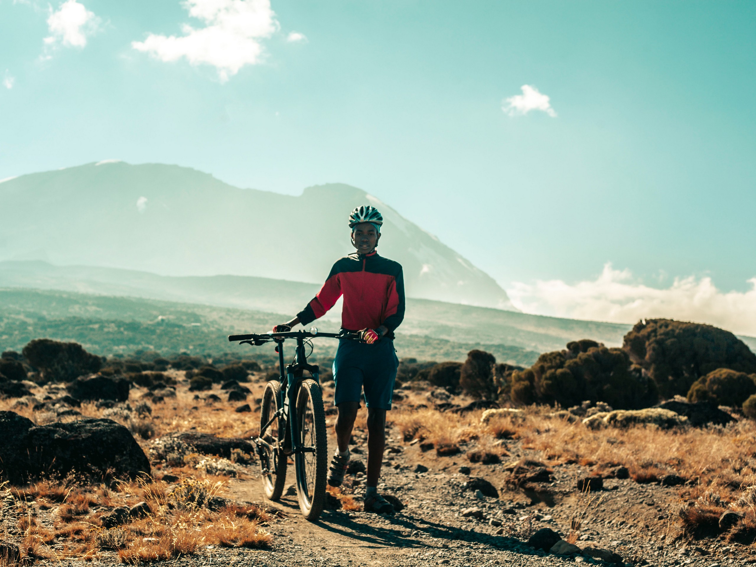 Cyclist on the way up to Mount Kilimanjaro, Tanzania