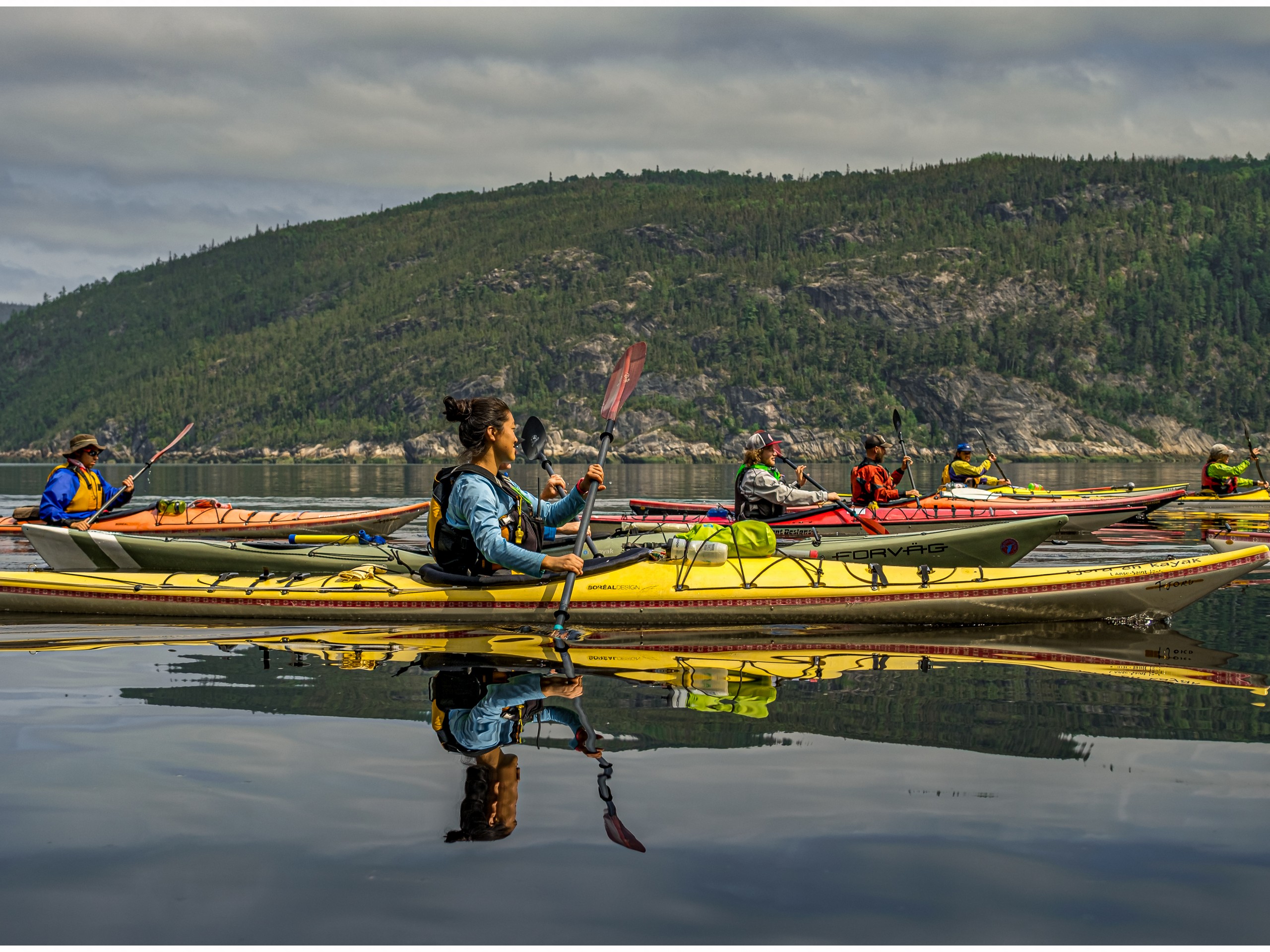 Group of kayakers sea kayaking in Quebec