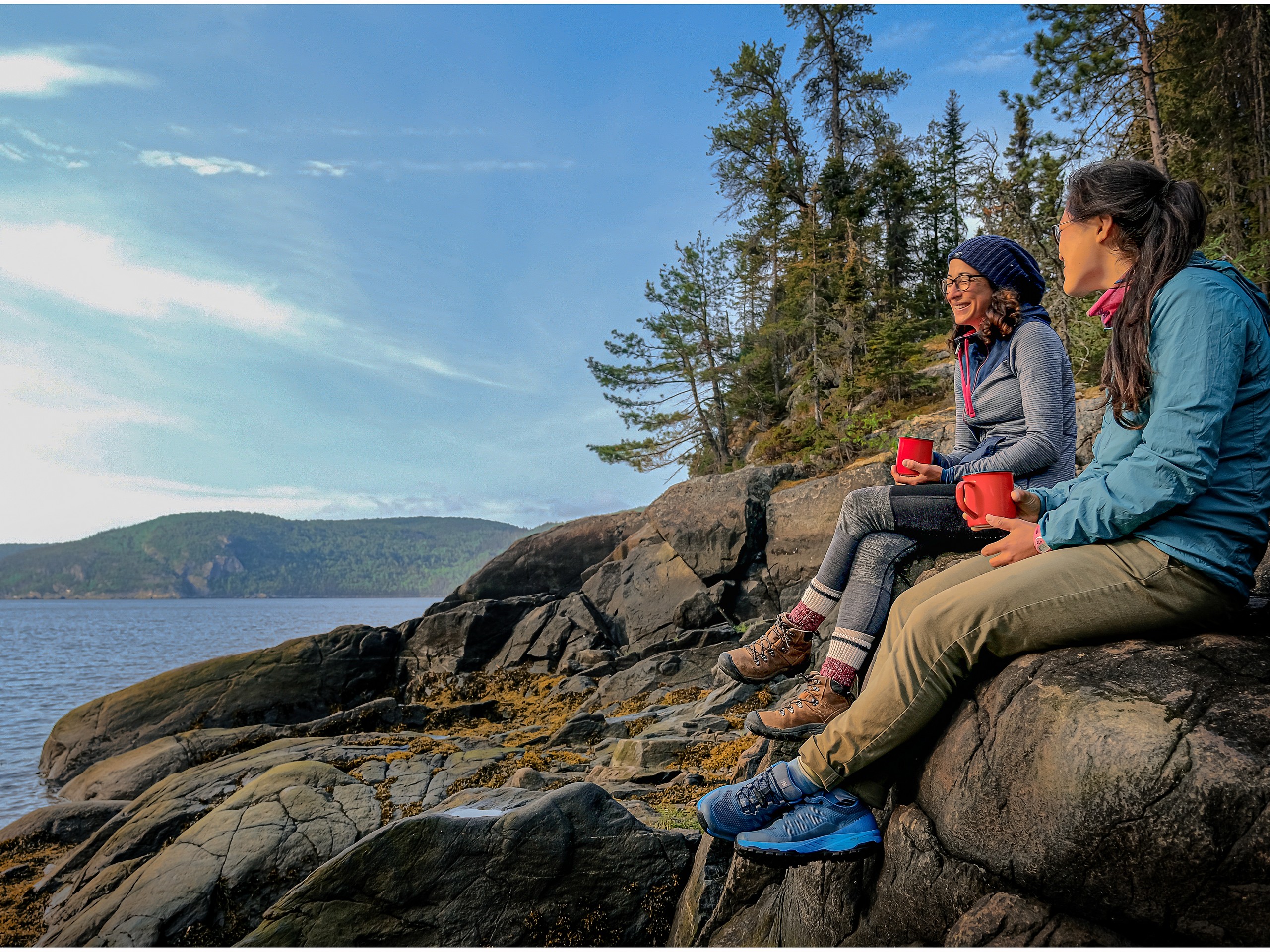 Two girls enjoying the lunch break in Quebec, after a long kayaking day