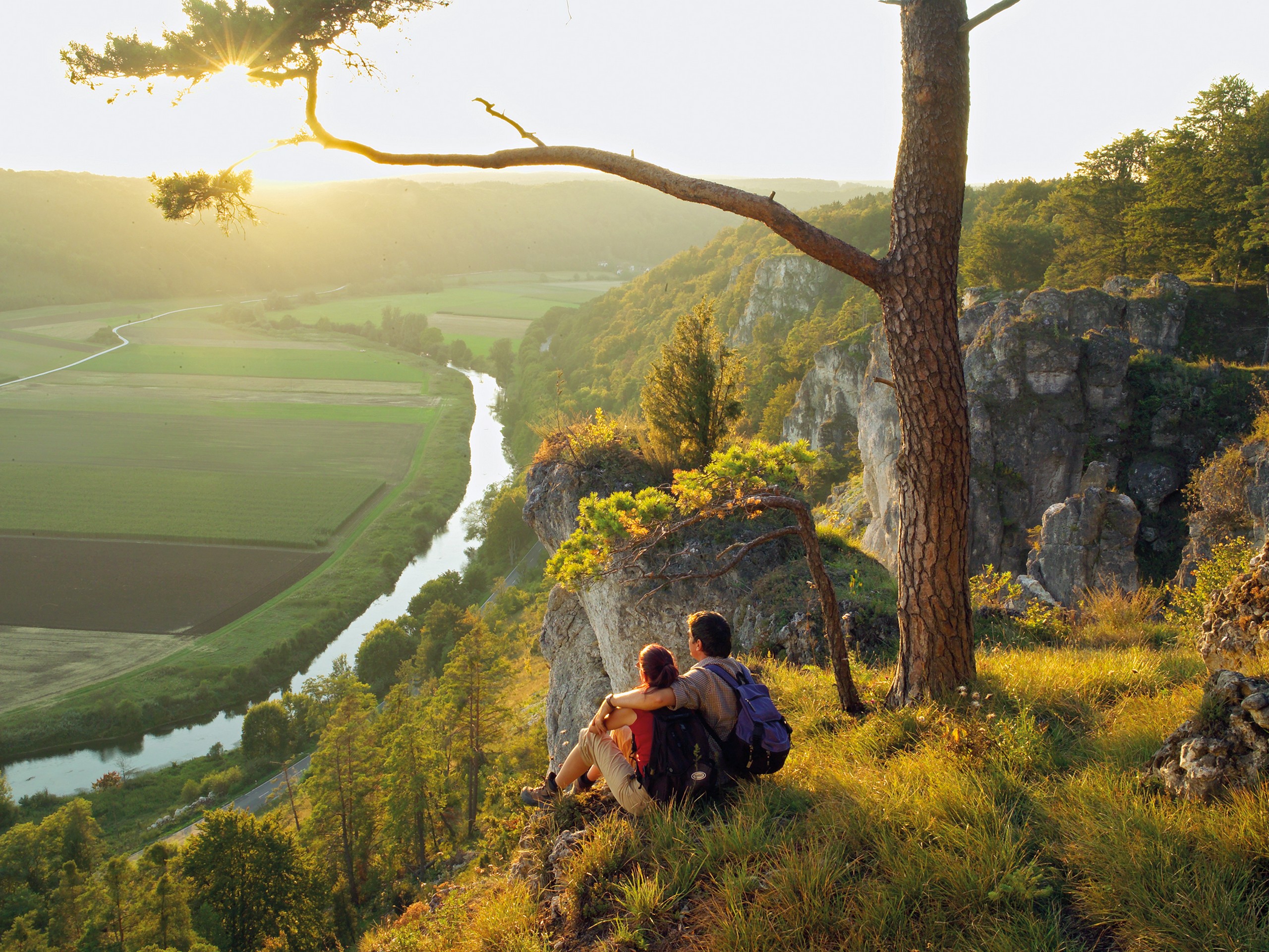 Altmühltal Panorama Trail Tour - Couple sitting and looking at the river below