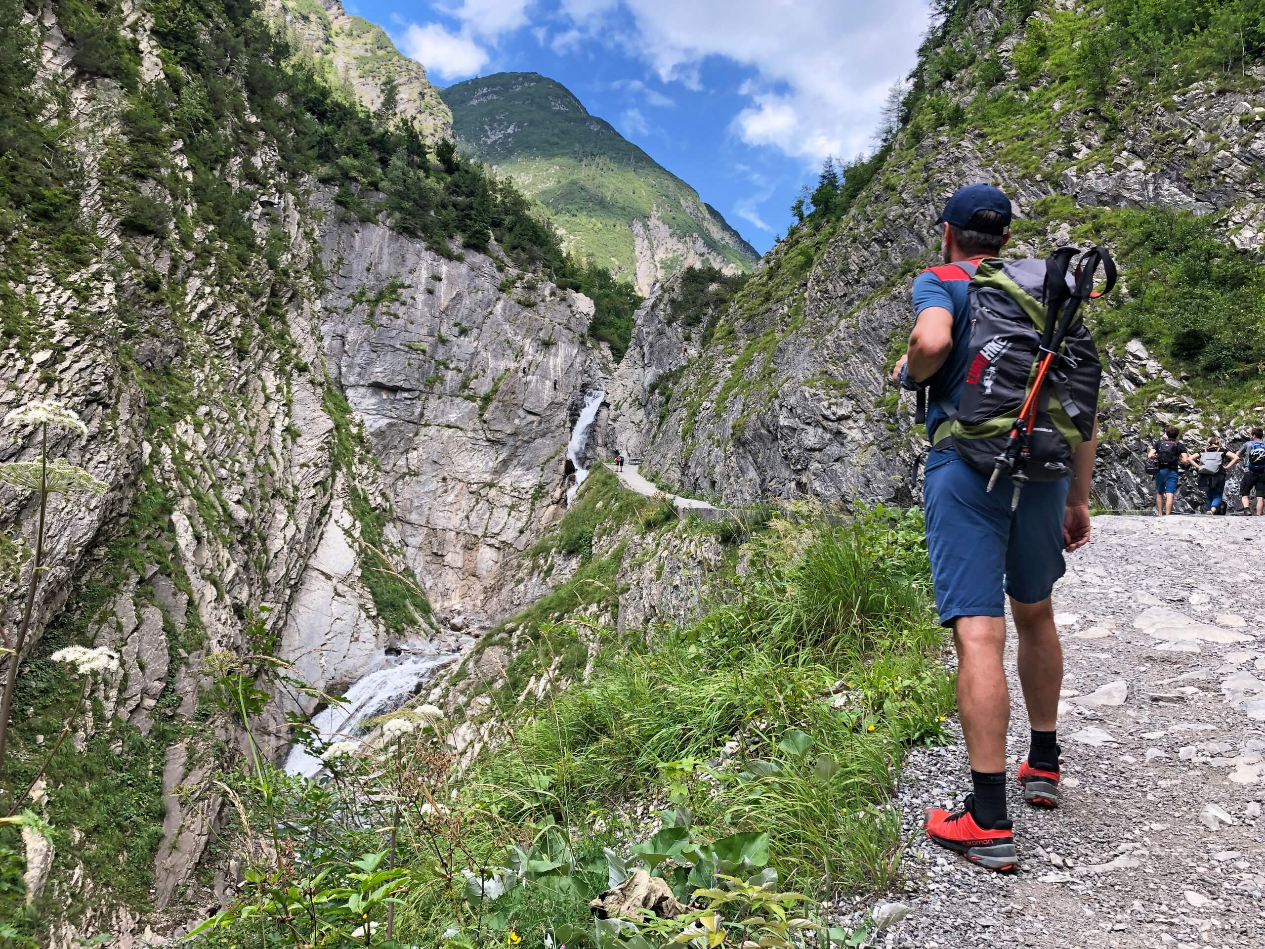 Hiker looking at the waterfall in the distance