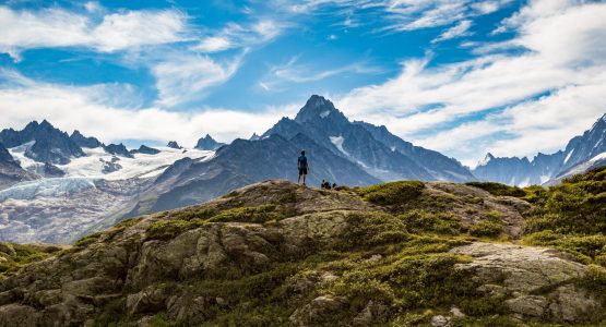 Hiker Looking At Glaciers While On Tour Du Mont Blanc Trek