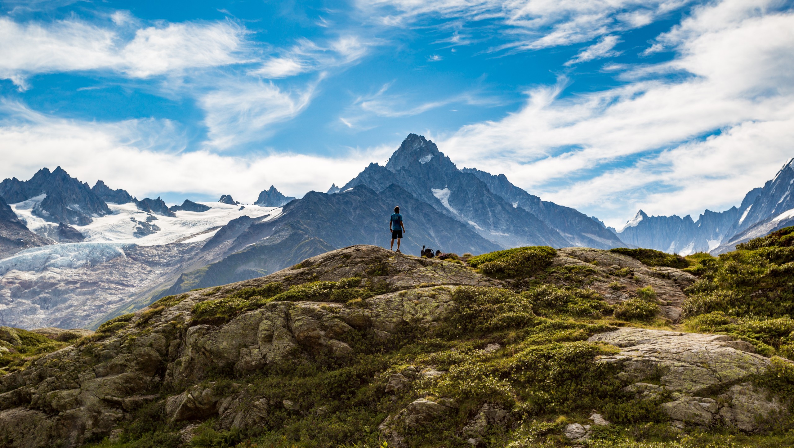 Hiker Looking At Glaciers While On Tour Du Mont Blanc Trek