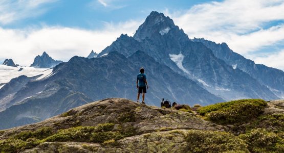 Hiker Looking At The Stunning Glaciers While On Tour Du Mont Blanc Trek