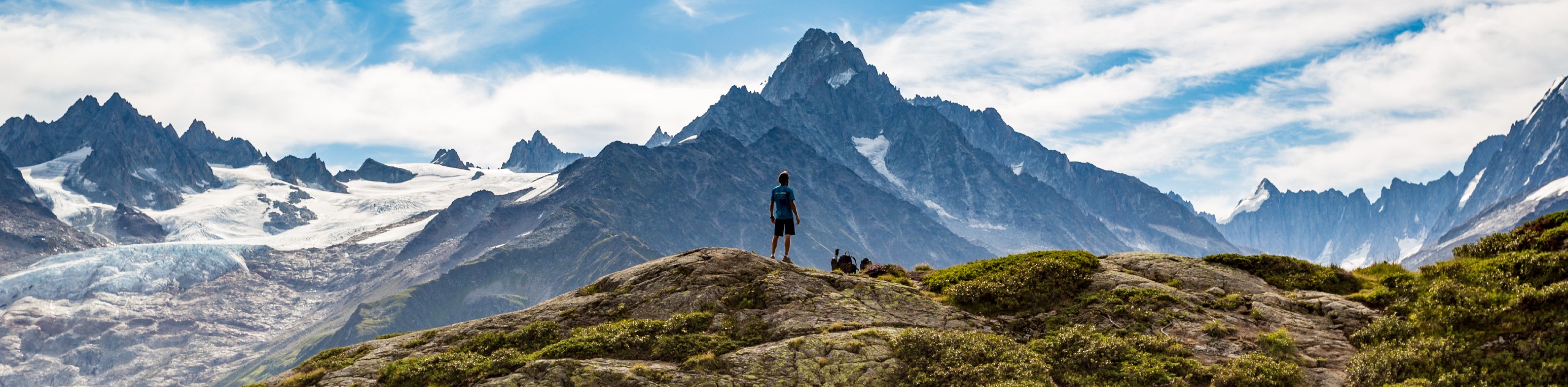 Hiker Looking At The Stunning Glaciers While On Tour Du Mont Blanc Trek