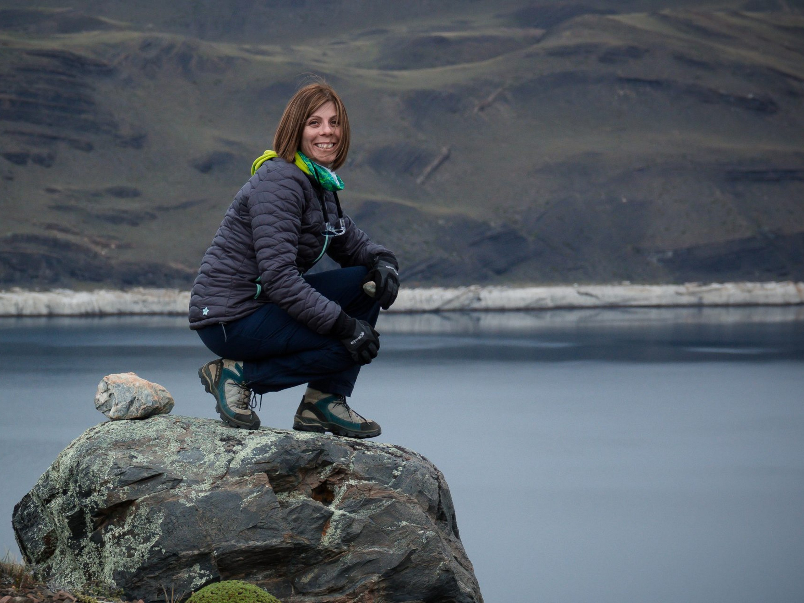 Lady posing on a rock near Patagonias shores