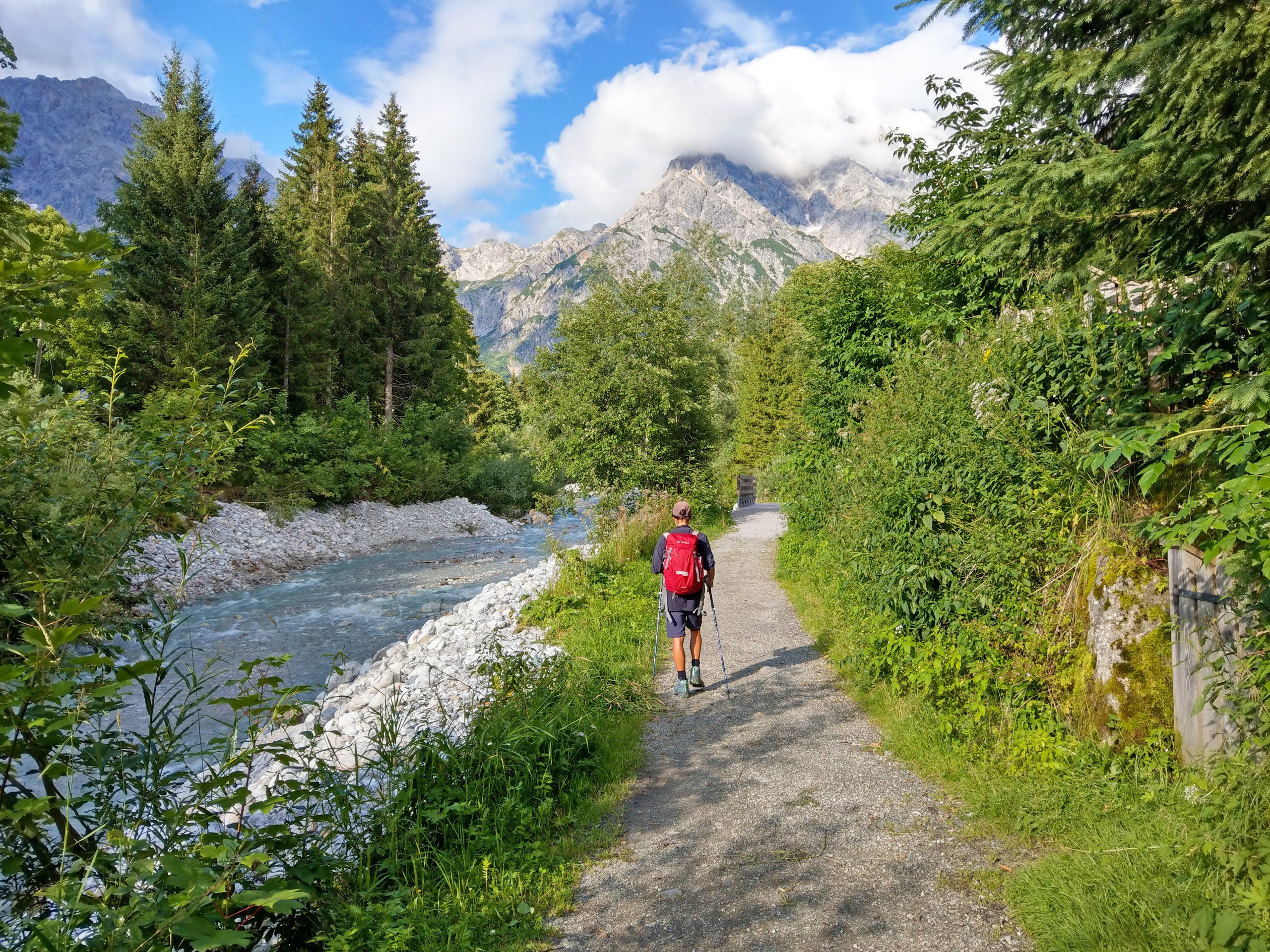 Hiker walking along the river in Zell am See region