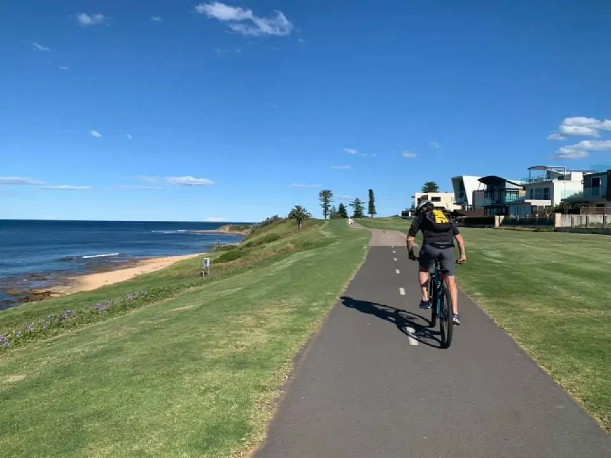 Cyclist riding along the beach in Australia